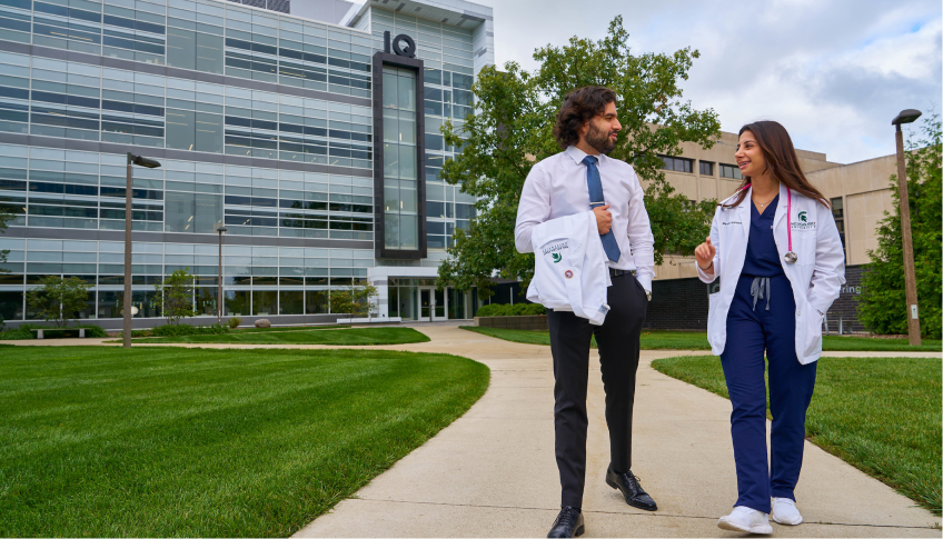Medical professionals walking on a sidewalk