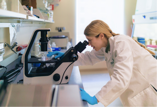 Woman looking through a microscope