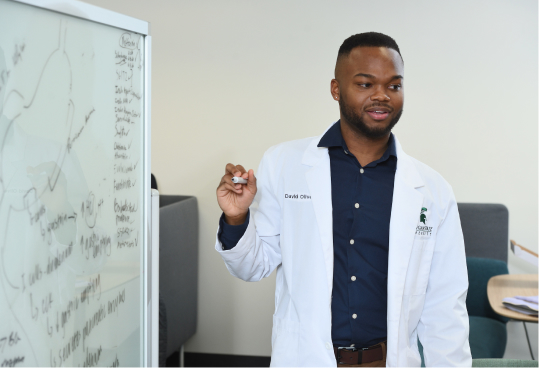 Instructor working on a white board