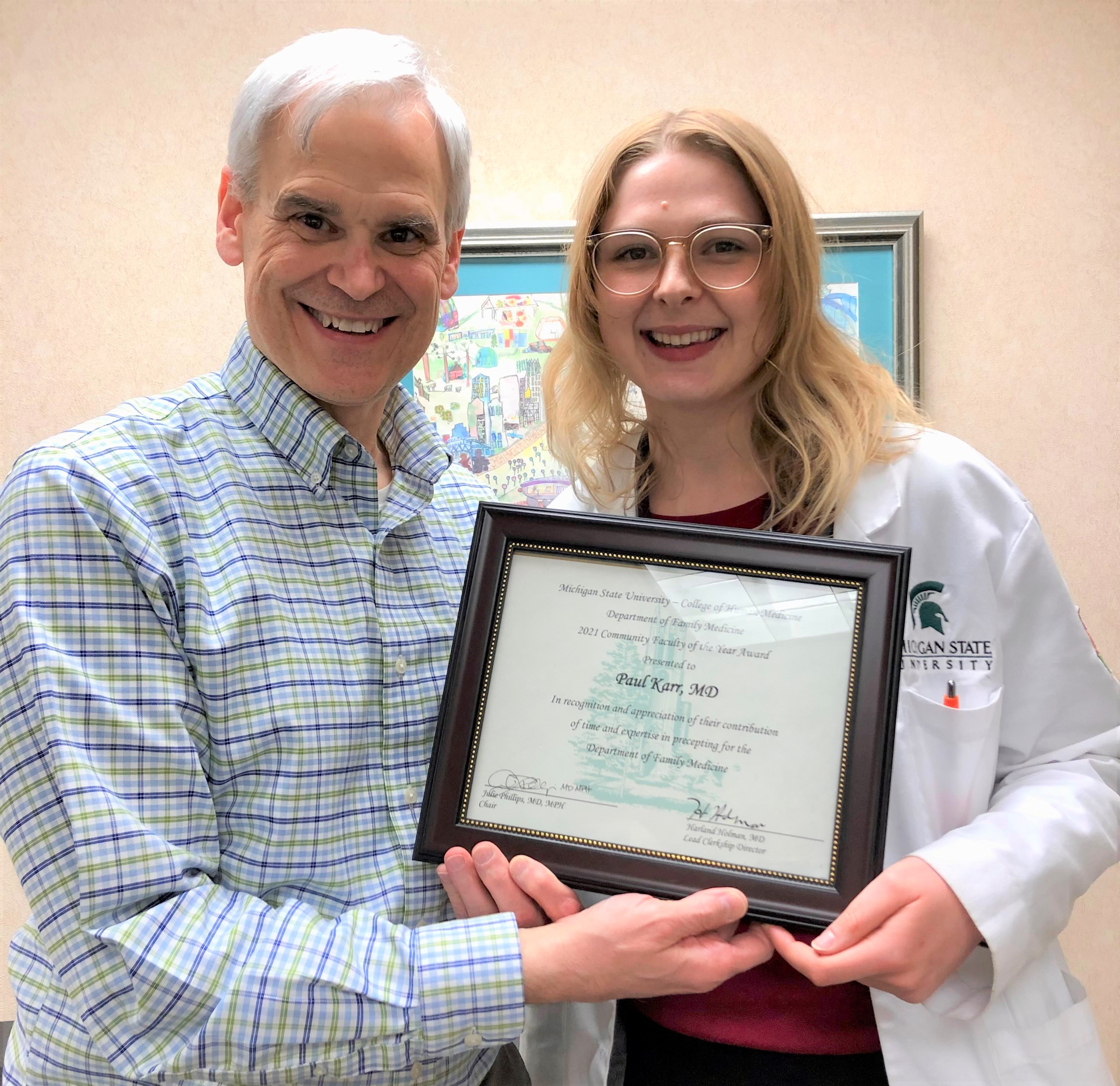 Dr. Paul Karr receiving the Flint Family Medicine Preceptor of the Year award